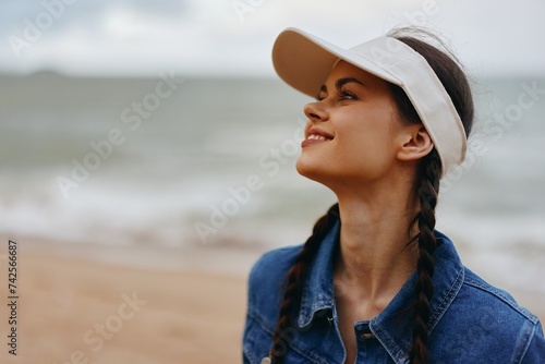 Smiling Woman  Young and Attractive  Enjoying a Relaxing Beach Vacation  A Pretty Lady in a Summer Hat  Posing Outdoors with a Bright Blue Sky and Tropical Background.