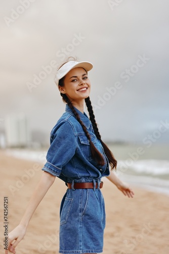Beautiful Young Lady Enjoying Summer Fashion Outdoors: Attractive Female Model with Elegant Hat Smiling by the Sea © SHOTPRIME STUDIO