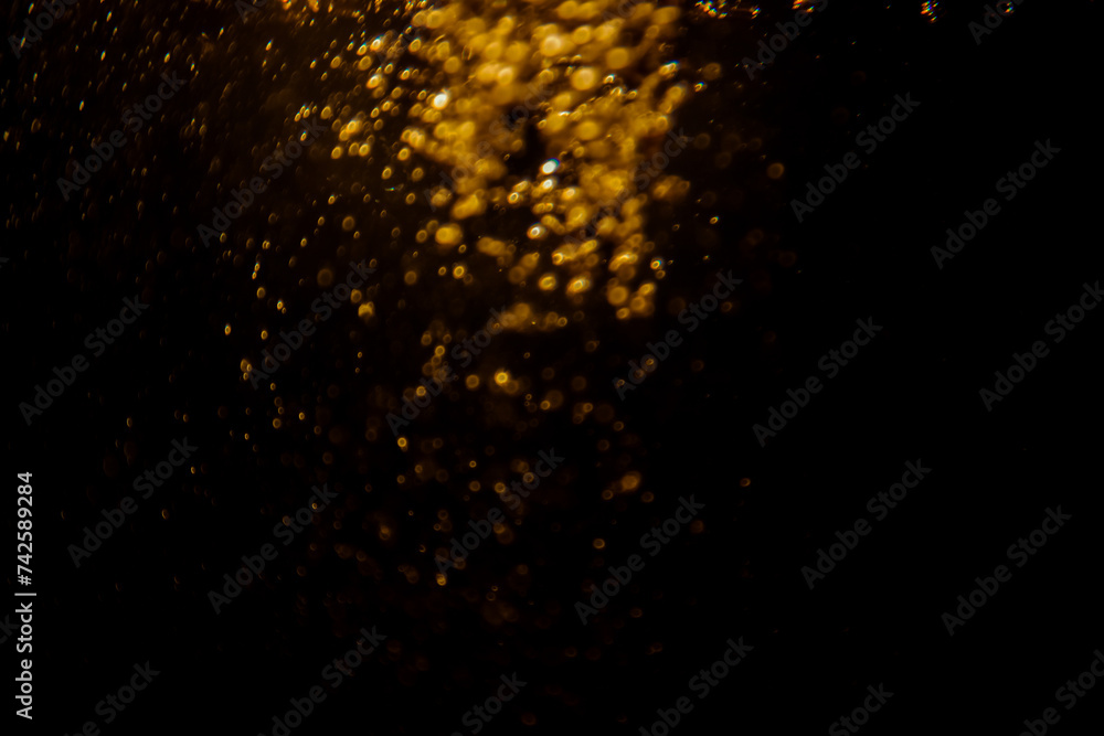 Blurred photo with golden dots visible glittering, shining brightly look and feel luxurious Suitable for use as a wallpaper