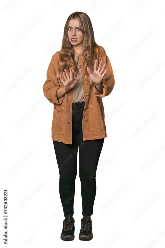 Studio portrait of a blonde Caucasian woman rejecting someone showing a gesture of disgust. Studio portrait of a blonde Caucasian woman rejecting someone showing a gesture of disgust.