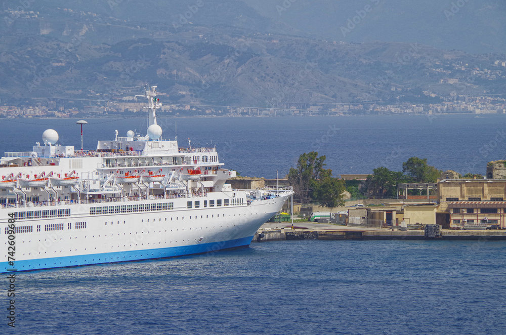 Classic cruiseship cruise ship liner Celebration docked at pier in Messina Sicily port, Italy during Summer Mediterranean cruising near Taormina Classic cruiseship cruise ship liner Celebration docked at pier in Messina Sicily port, Italy during Summer Mediterranean cruising near Taormina