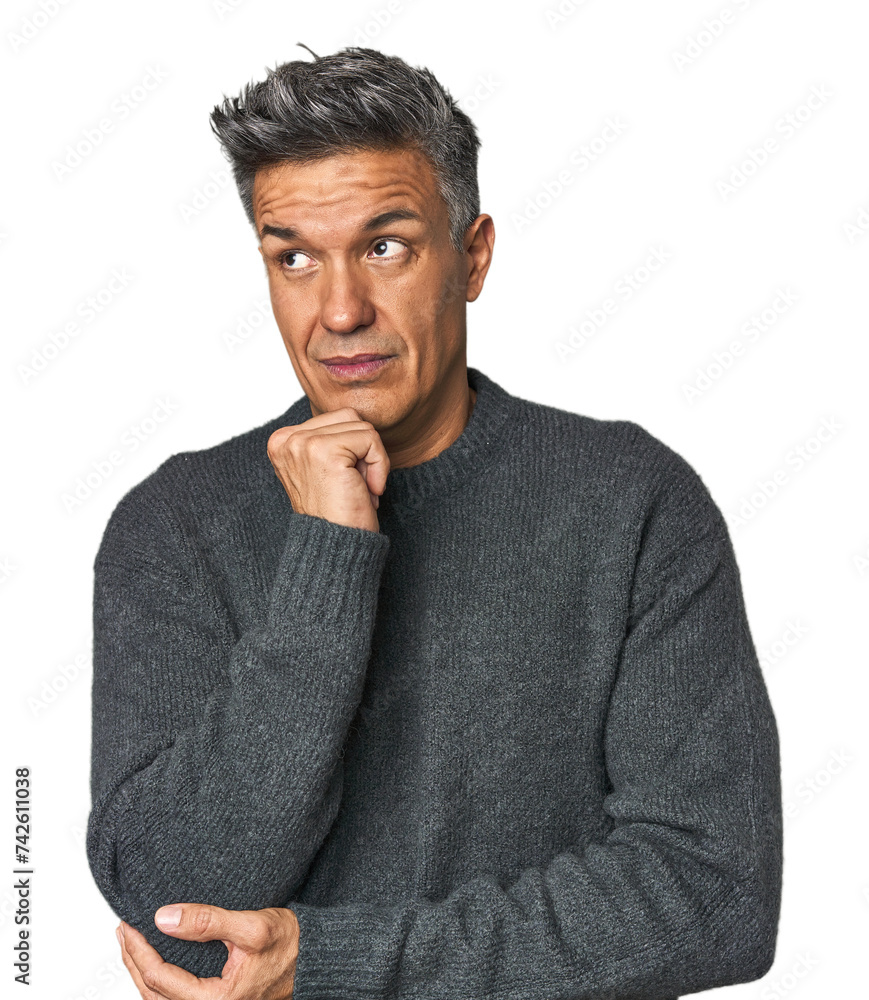 Middle-aged Latino man thinking and looking up, being reflective, contemplating, having a fantasy. Middle-aged Latino man thinking and looking up, being reflective, contemplating, having a fantasy.