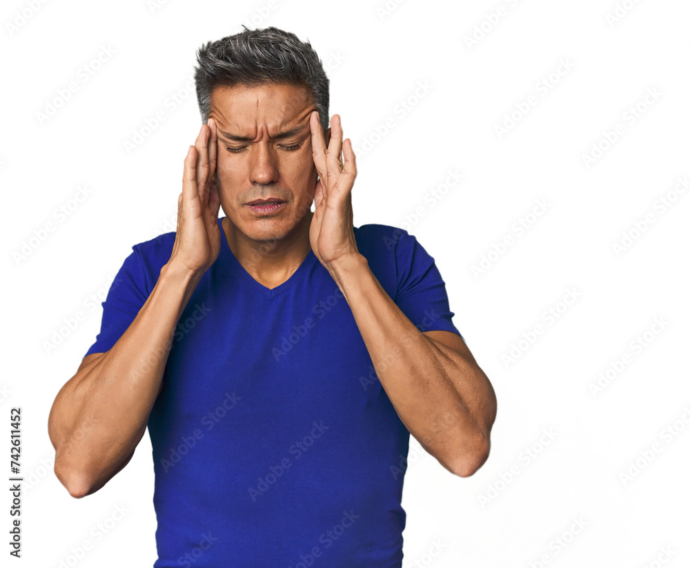 Fototapeta premium Middle-aged Latino man touching temples and having headache.