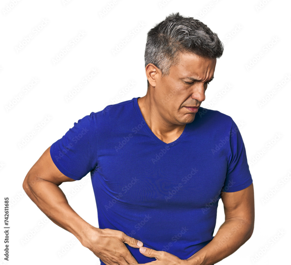 Middle-aged Latino man having a liver pain, stomach ache. Middle-aged Latino man having a liver pain, stomach ache.