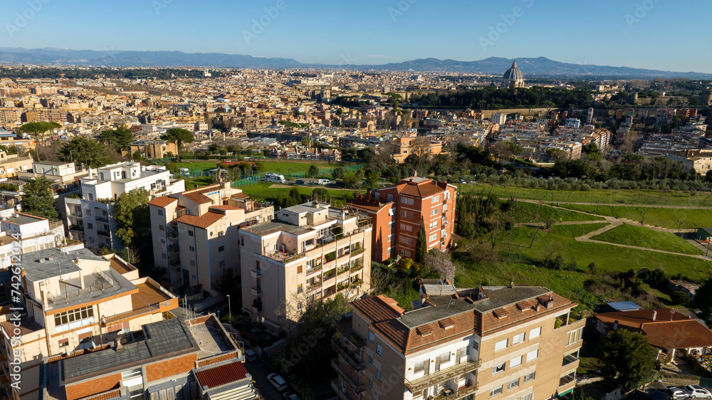 Aerial view of Prati neighborhood in Rome, Italy. In the background there is the dome of St. Peter's Basilica in Vatican City. In the foreground there is Monte Ciocci and Ettore Scola park.