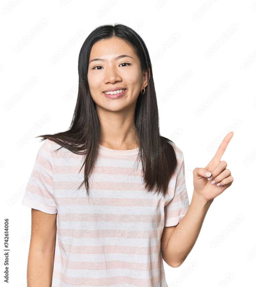 Young Chinese woman in studio setting showing number one with finger. Young Chinese woman in studio setting showing number one with finger.