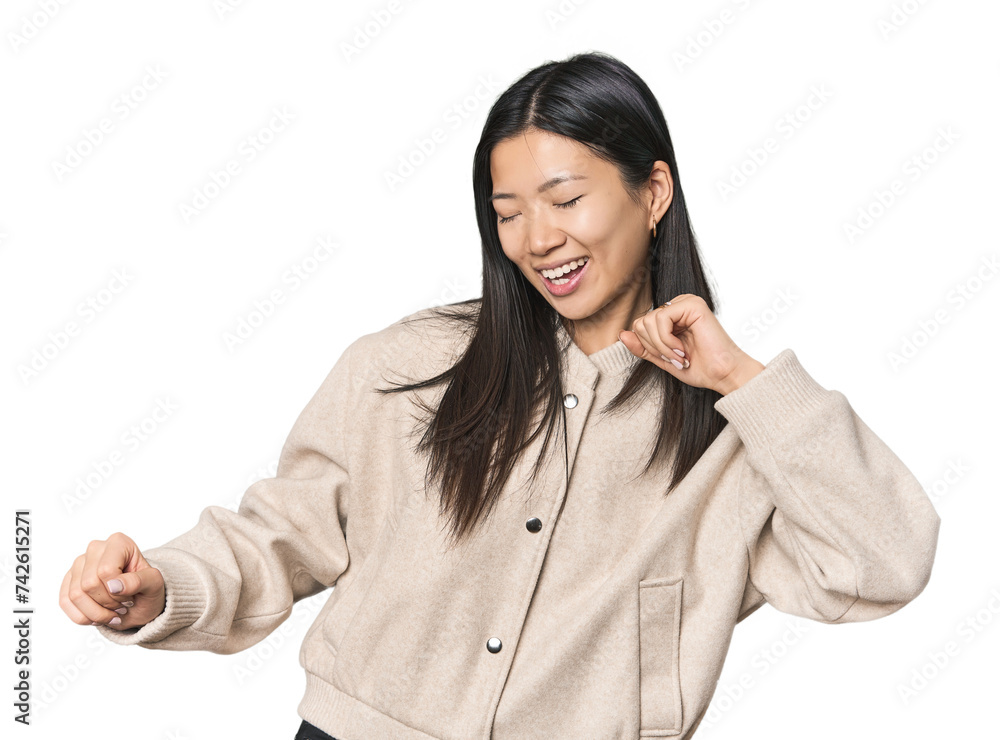 Young Chinese woman in studio setting dancing and having fun. Young Chinese woman in studio setting dancing and having fun.