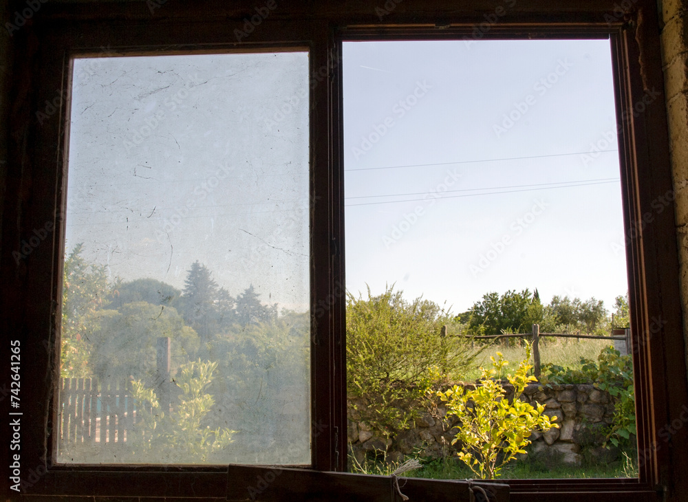 Naklejka premium Old Window overlooking the field. Countryside.