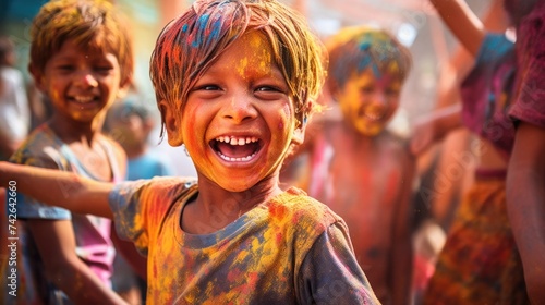 Happy people celebrating holi. the child laughs and throws paint and multi-colored powder. holy holiday in india