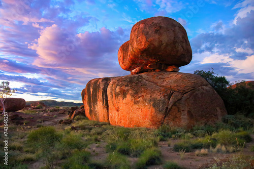 Devils Marbles (Karlu Karlu in Aboriginal language) at dusk in the Australian Red Center, Northern Territory - Granite boulders formed by erosion and natural weathering in bushland photo
