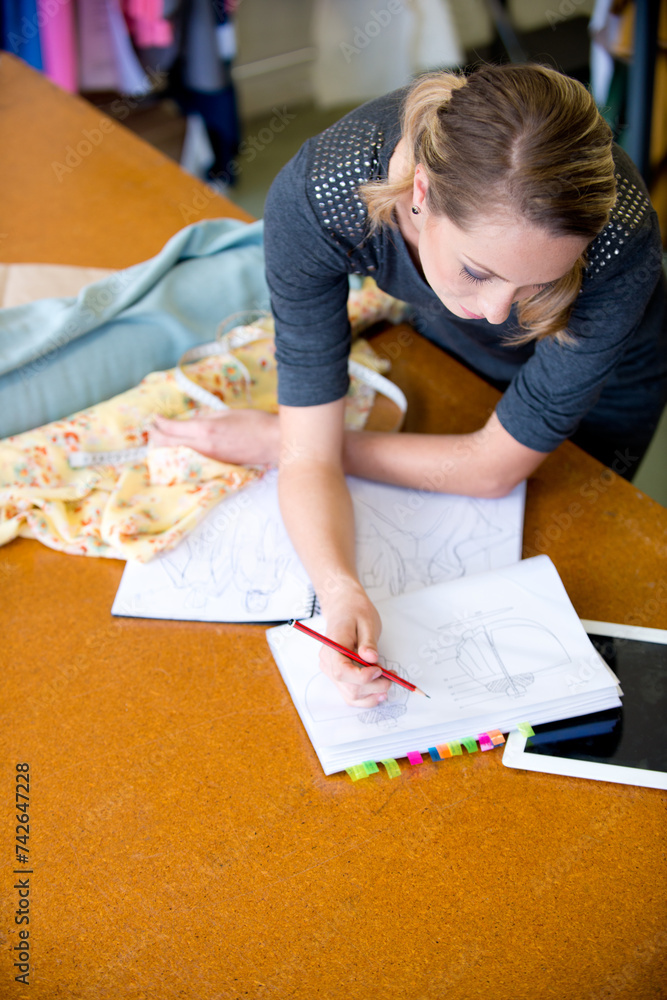 Fashion designer and drawing costume design with style, artistic or inspiration at desk with mockup. Pencil, female person or fabric with stylish, fashionable or pattern for clothing with creativity Fashion designer and drawing costume design with style, artistic or inspiration at desk with mockup. Pencil, female person or fabric with stylish, fashionable or pattern for clothing with creativity