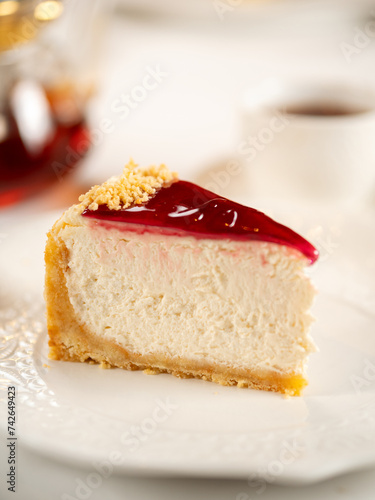 Piece of appetizing cheesecake on restaurant table. Delicious new york cheesecake glazed berries jam