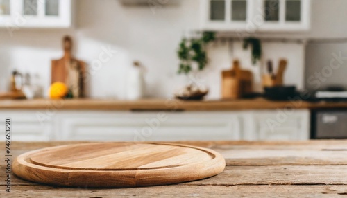 cutting board on table in blurred kitchen interior with space