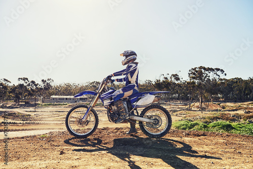 Fototapeta Naklejka Na Ścianę i Meble -  Man, motorbike and outdoor on trail for extreme sport in profile on dirt, path or countryside in summer. Person, motorcycle and gravel on road with vehicle, machine or fast transport in competition