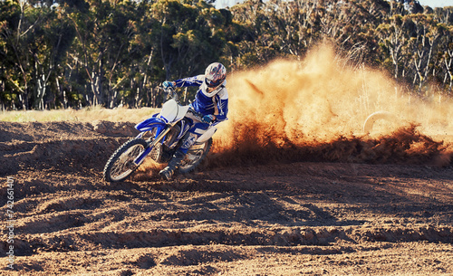 Fototapeta Naklejka Na Ścianę i Meble -  Person, dirt bike and professional motorcyclist racing in extreme sports or competition on outdoor track. Expert rider on motorbike or scrambler for sand course, challenge or off road rally in nature