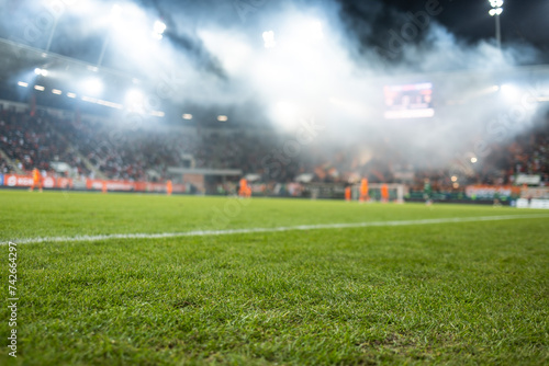 white line on the field soccer match and pirotechnic smoke in the background