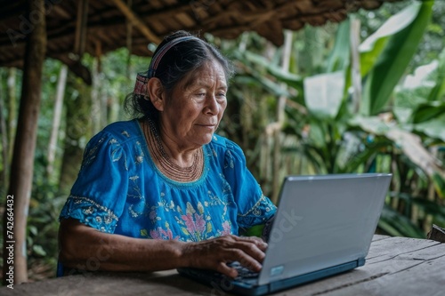 Elderly Indigenous Woman Engaging with Technology in a Rural Setting: A Blend of Tradition and Modernity