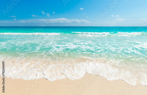 Sun shining over a tropical beach with turquoise water