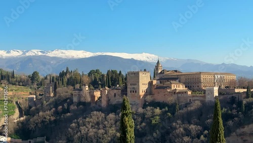Panoramic view of Alhambra with blue sky and Sierra Nevada in the background in Granada. Andalusia, Spain.