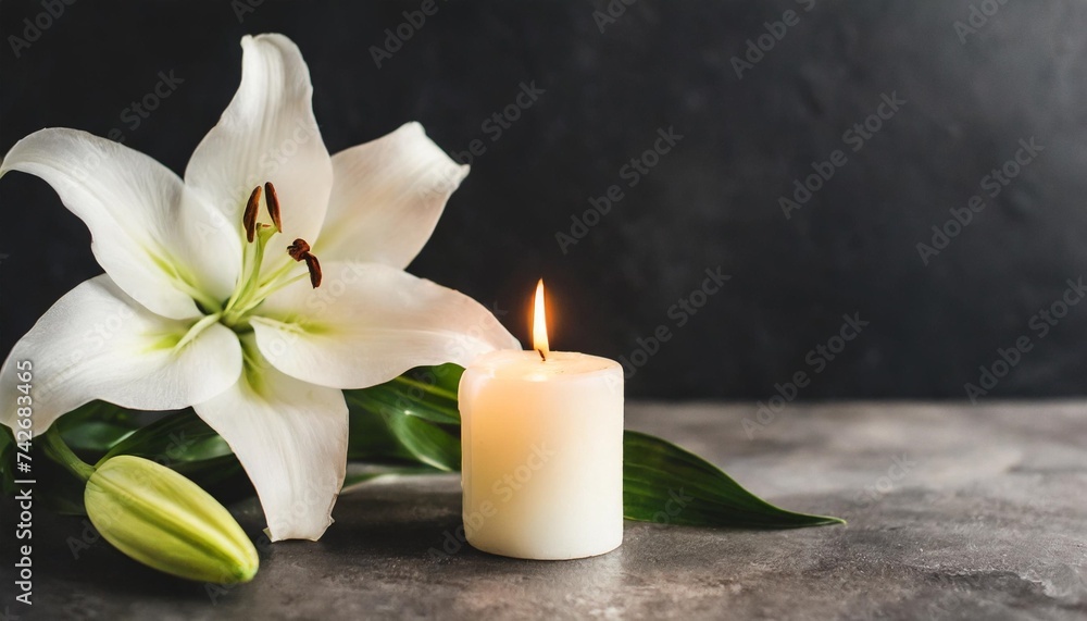 beautiful lily and burning candle on dark background with space for text funeral white flowers