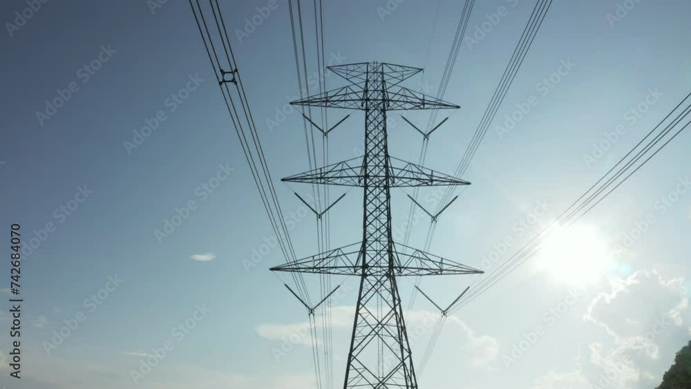 Transmission tower in aerial view. May called electricity pylon, steel utility pole consist of steel structure framing to support carry high-voltage cable or overhead power line for electrical grid. Transmission tower in aerial view. May called electricity pylon, steel utility pole consist of steel structure framing to support carry high-voltage cable or overhead power line for electrical grid.