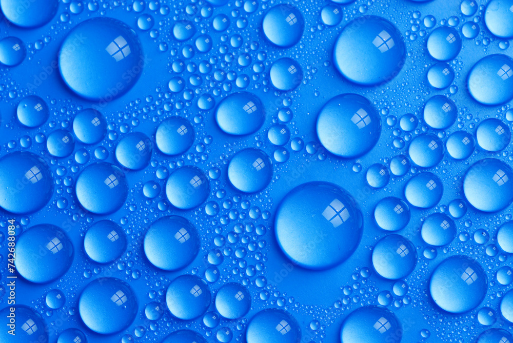 many small water drops on a blue surface