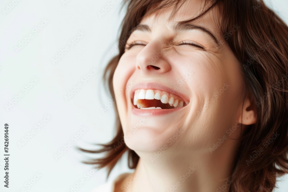 A school teacher looking at a computer laughing, full of emotion. A school teacher looking at a computer laughing, full of emotion.