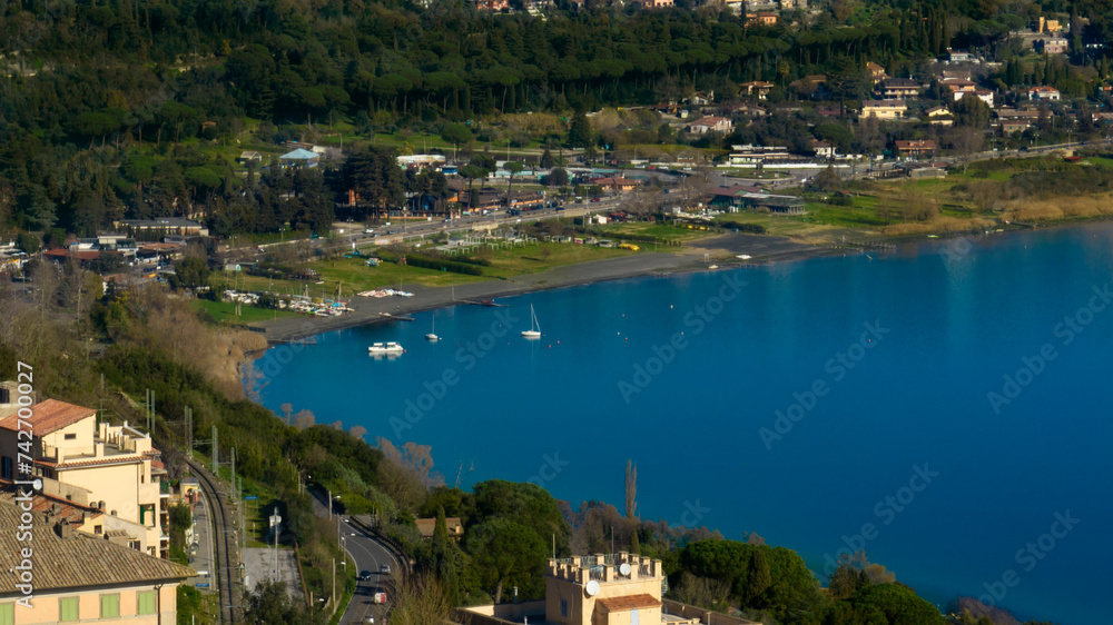 Aerial view of the Albano lake public beach from Castel Gandolfo, near Rome, Italy. It is a volcanic crater lake. Holidays at the lake concept.
