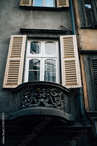 window with wooden shutters in France photo