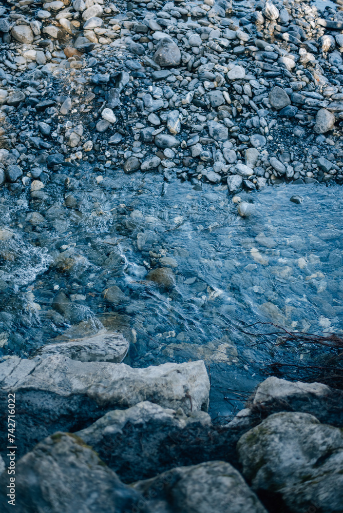 Sea rocky bottom under transparent blue water. Clear turquise lake surface rippled with sun ray reflection. Sea rocky bottom under transparent blue water. Clear turquise lake surface rippled with sun ray reflection.