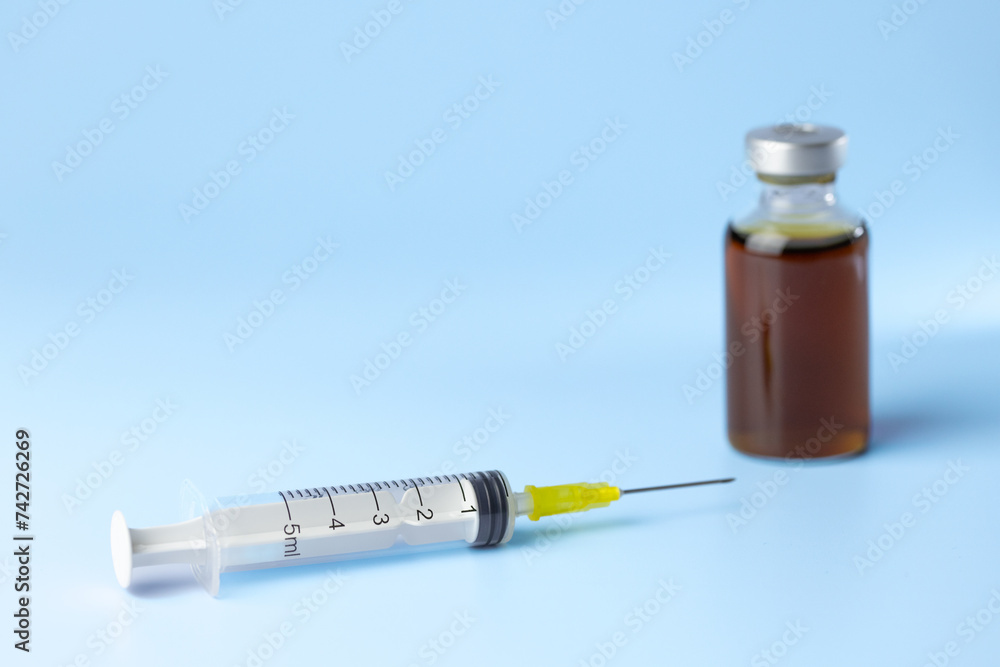syringe for injectable medication on blue background