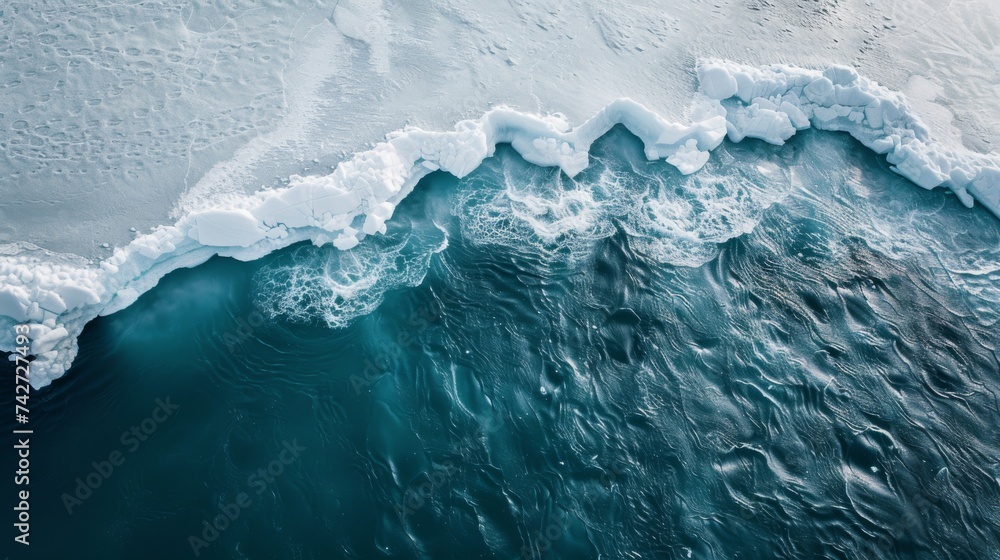 A big icefield in the water as seen from the top, a chunk of ice is falling off an iceberg into the water causing a big wave because of climate change - obrazy, fototapety, plakaty 