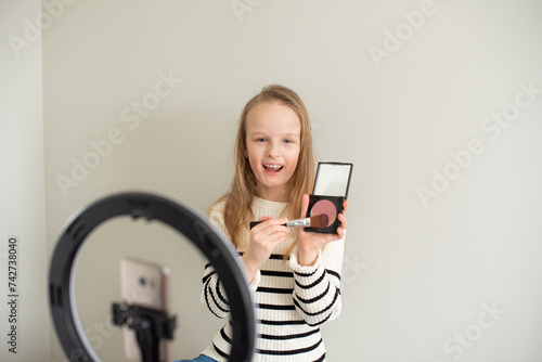 Little blond girl blogger filming new video, makeup beauty blog channel 