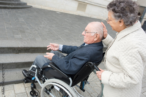 a senior couple in wheelchair © auremar