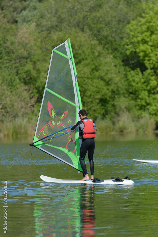 Naklejka premium a man is doing windsurf