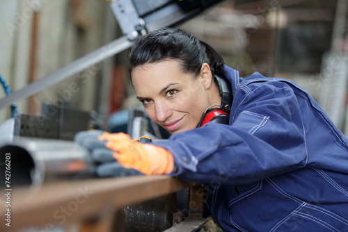 smily woman working with machine in industrial