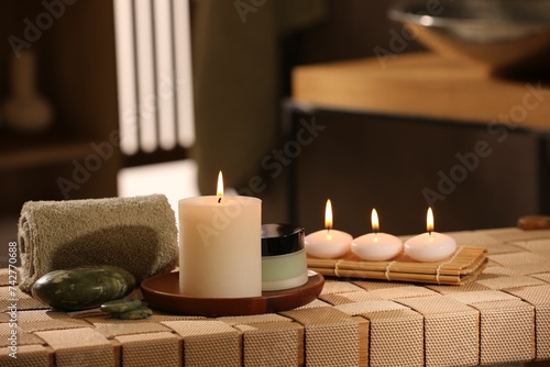 Beautiful composition with different spa products on wicker bench indoors