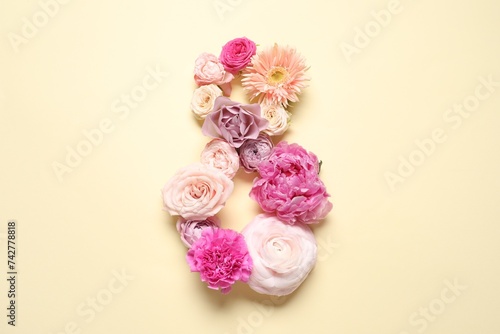 8 March greeting card design made with beautiful flowers on light yellow background, top view