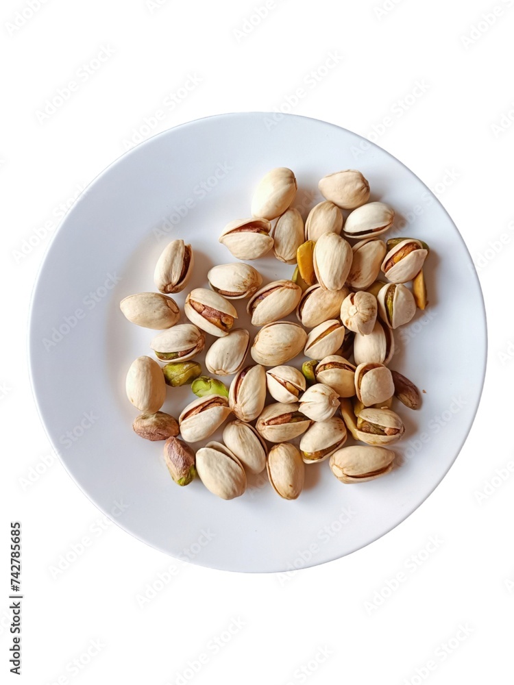 A pile of pistachios on a white plate. A pile of pistachios on a white plate.