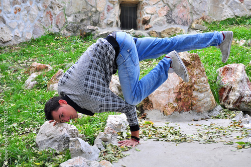 A young acrobatic dancer dances in nature