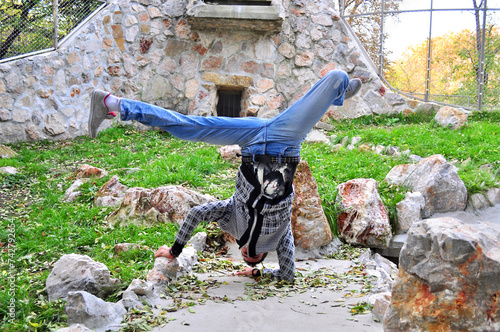 A young acrobatic dancer dances in nature