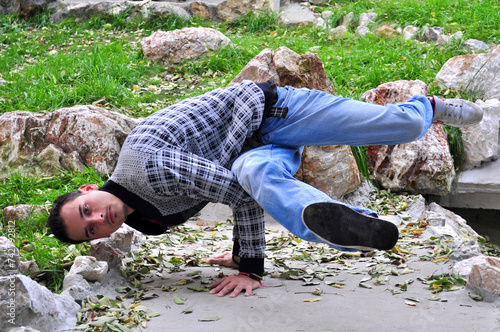 A young acrobatic dancer dances in nature