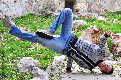 A young acrobatic dancer dances in nature