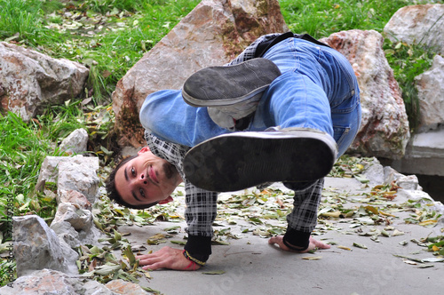 A young acrobatic dancer dances in nature