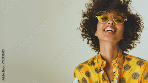 Afro woman wearing yellow shirt smiling laugh out loud isolated on grey