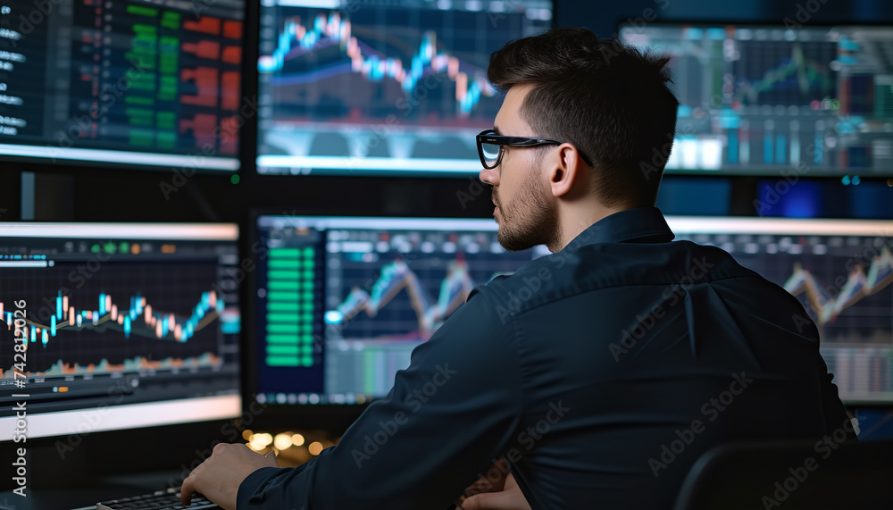 Fototapeta premium businessman working on multiple screens