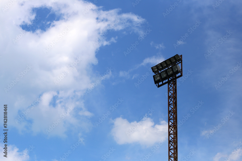 Big light pole on the blue sky background. Big light pole on the blue sky background.