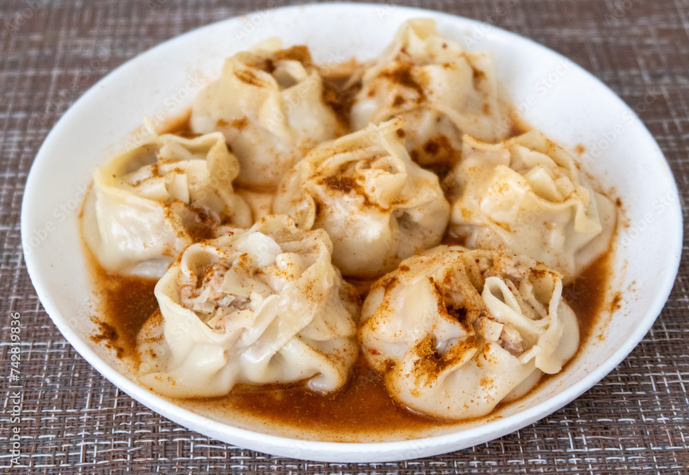 manti sprinkled with pepper on a plate, asian food manti sprinkled with pepper on a plate, asian food