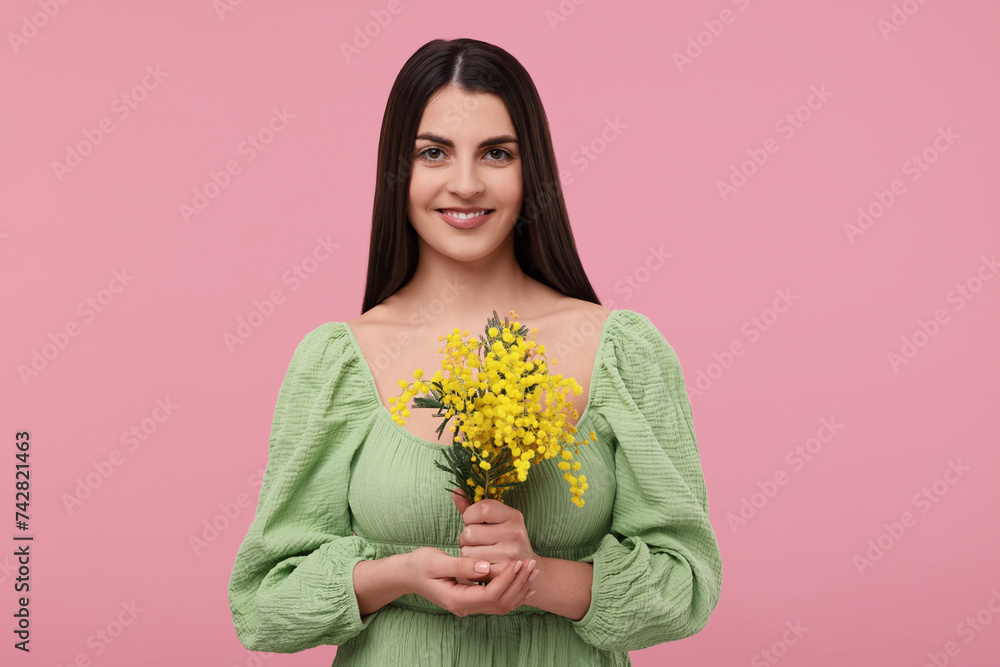 Happy young woman with beautiful bouquet on dusty pink background Happy young woman with beautiful bouquet on dusty pink background