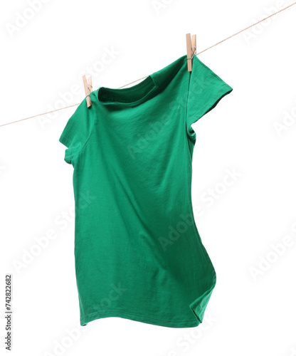 One green t-shirt drying on washing line isolated on white